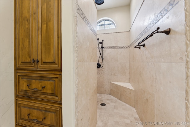 bathroom with tiled shower