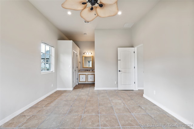 unfurnished bedroom featuring connected bathroom and ceiling fan