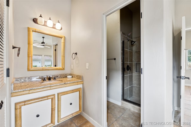 bathroom with vanity, tile patterned floors, ceiling fan, and walk in shower