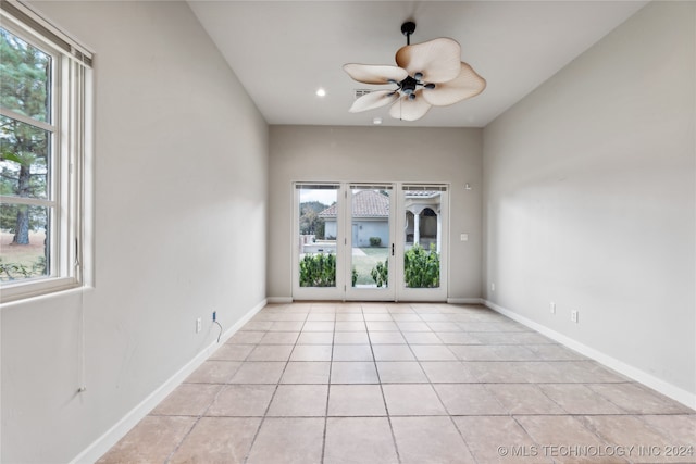 tiled empty room featuring ceiling fan