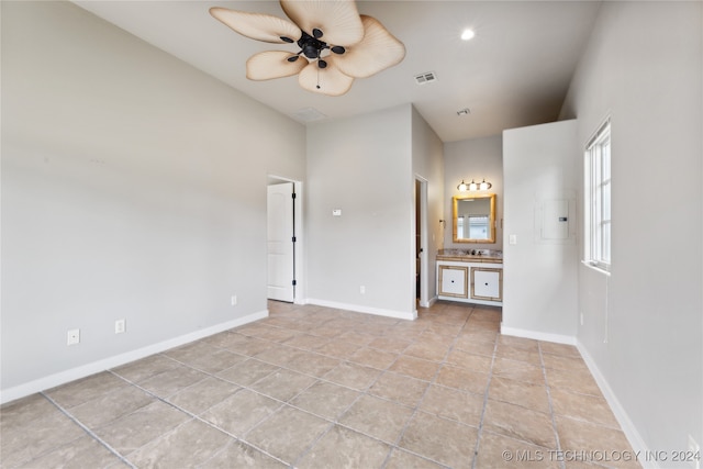 tiled spare room with ceiling fan