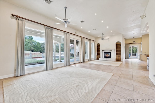 unfurnished living room with light tile patterned flooring and ceiling fan