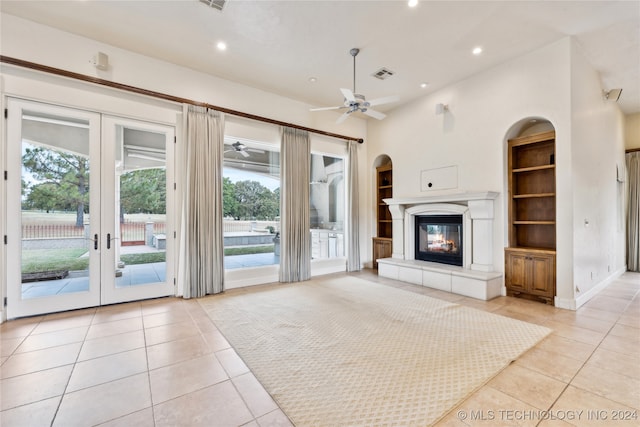 unfurnished living room featuring french doors, ceiling fan, high vaulted ceiling, and light tile patterned flooring