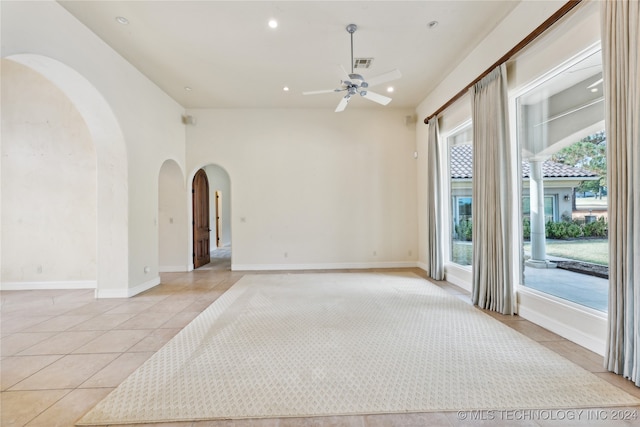 unfurnished room with light tile patterned floors and ceiling fan