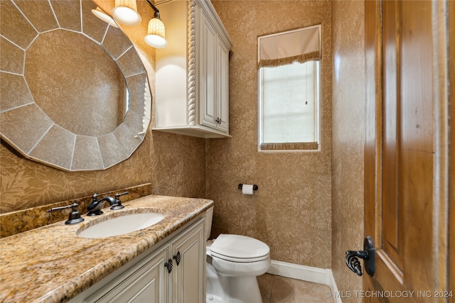 bathroom featuring vanity, toilet, and tile patterned floors