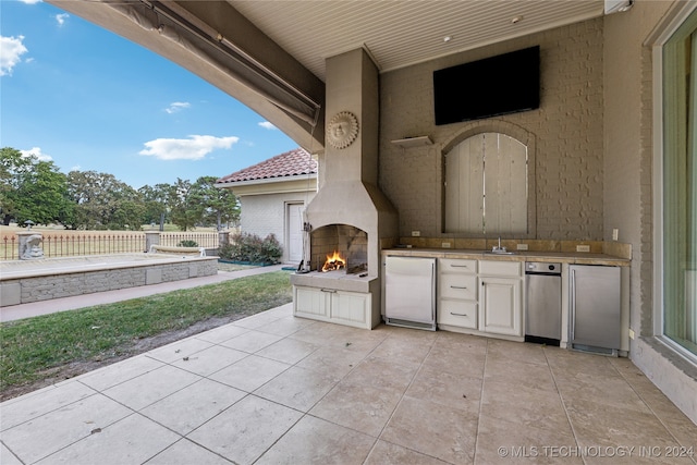 view of patio featuring area for grilling and sink