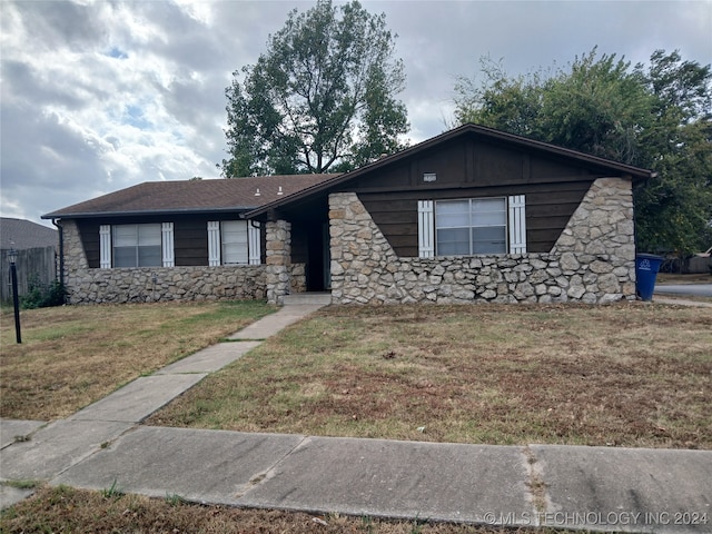 ranch-style house with a front lawn