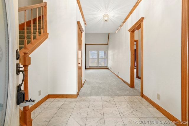 corridor featuring light carpet and ornamental molding