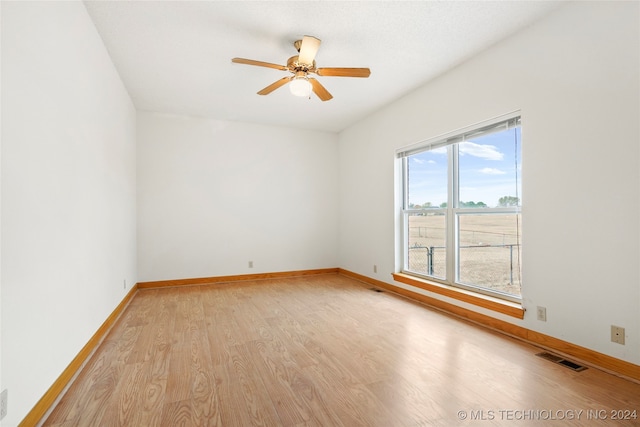 spare room with light hardwood / wood-style floors and ceiling fan