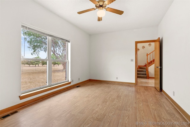 unfurnished room featuring a healthy amount of sunlight, light wood-type flooring, and ceiling fan