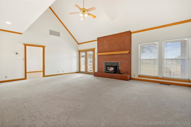 unfurnished living room featuring light colored carpet, crown molding, high vaulted ceiling, and ceiling fan