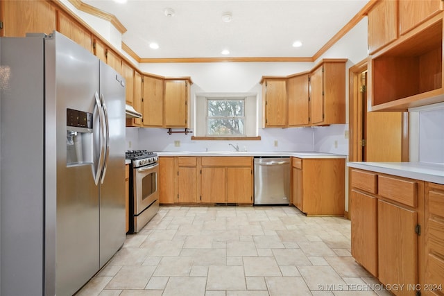 kitchen with appliances with stainless steel finishes, crown molding, and sink