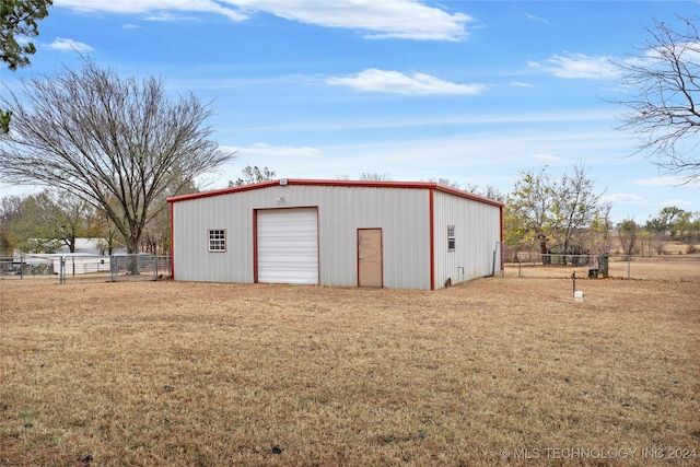 view of outbuilding with a garage and a lawn