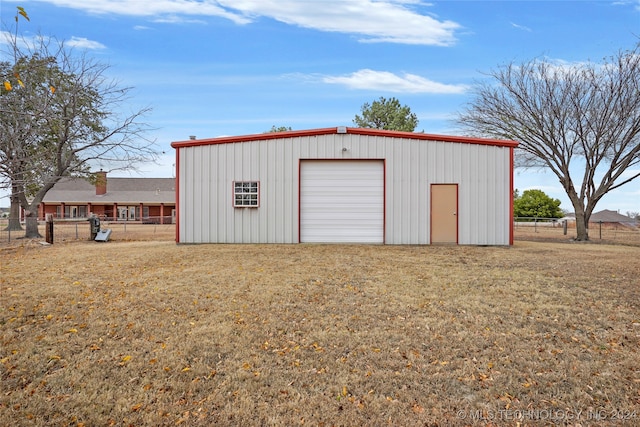 view of outbuilding featuring a yard and a garage