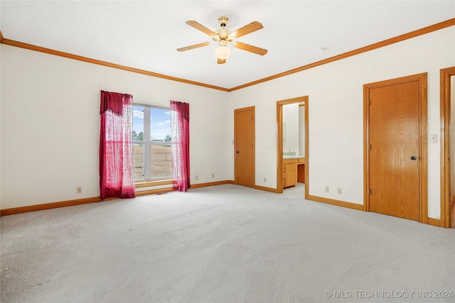 carpeted spare room featuring ornamental molding and ceiling fan