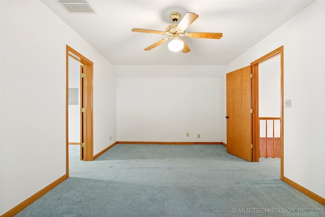 carpeted empty room with ceiling fan