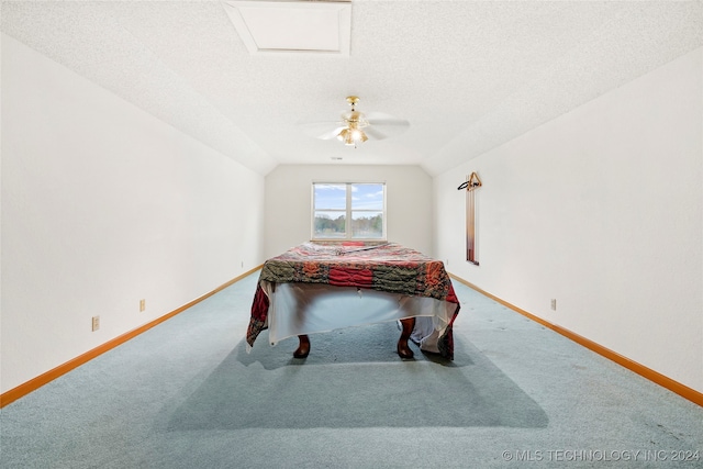 carpeted bedroom featuring ceiling fan, a textured ceiling, and lofted ceiling