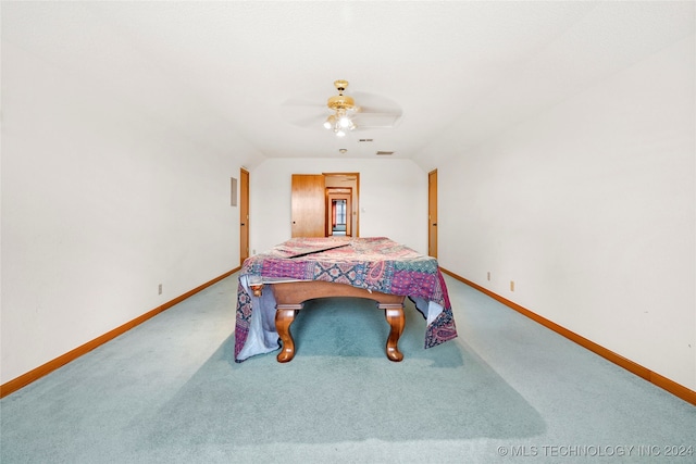 bedroom with ceiling fan, lofted ceiling, and carpet floors