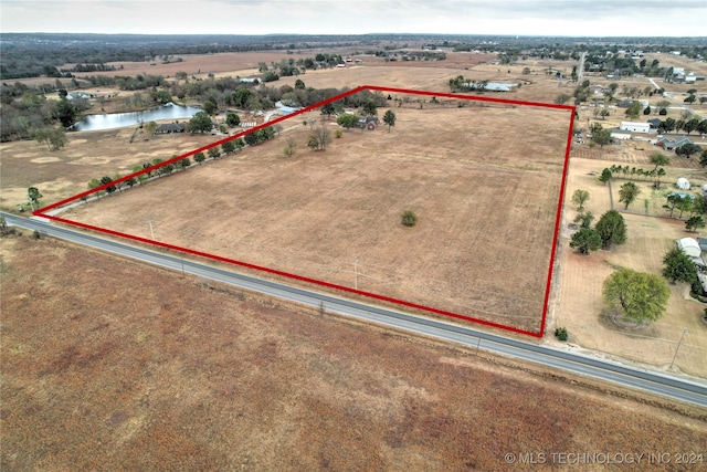 birds eye view of property with a water view and a rural view