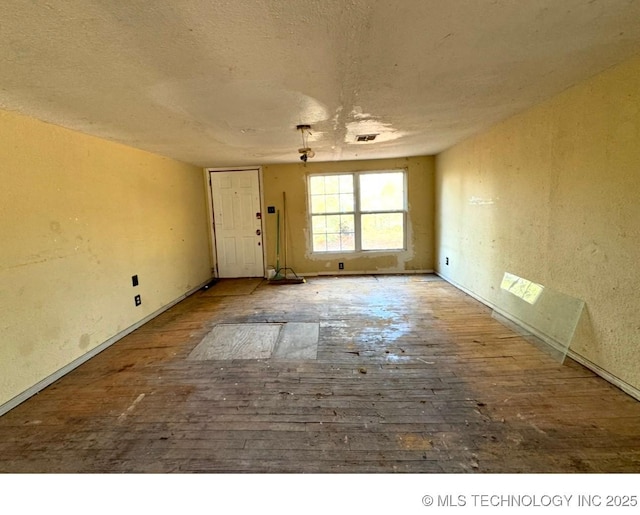 unfurnished room with a textured ceiling