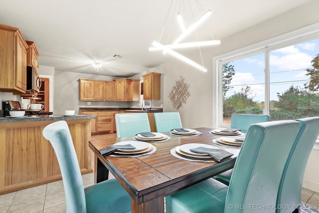 dining room featuring light tile patterned flooring and a notable chandelier