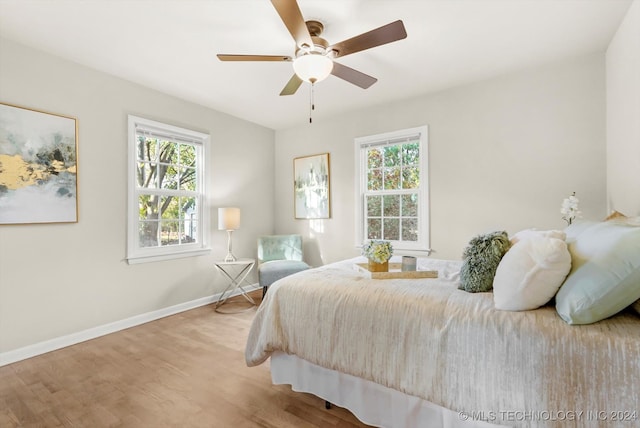 bedroom with light hardwood / wood-style floors and ceiling fan