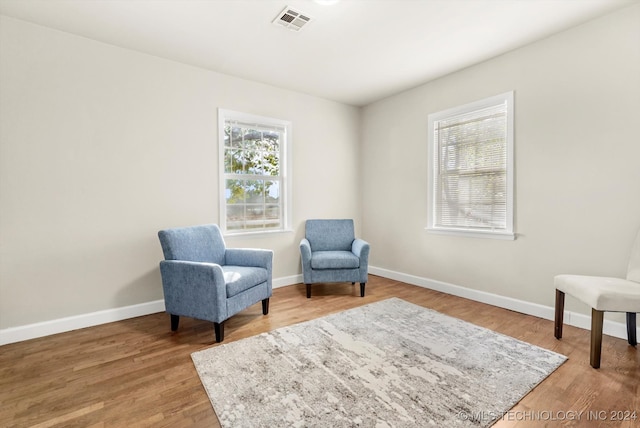 sitting room featuring hardwood / wood-style floors and plenty of natural light