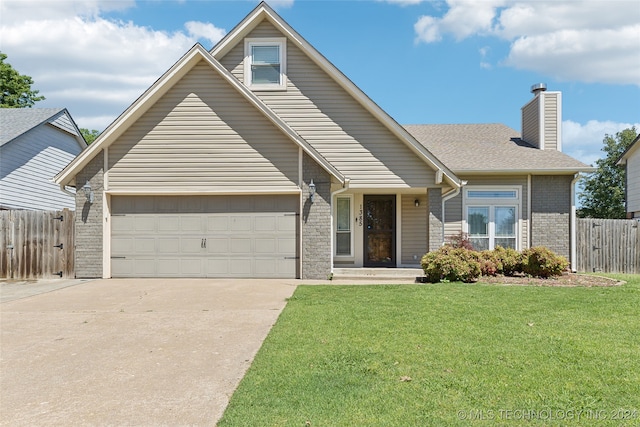 view of front of house featuring a front yard and a garage