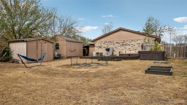 exterior space with a storage unit and a yard