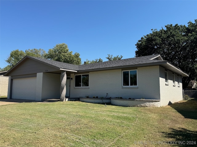 ranch-style home with a front yard and a garage