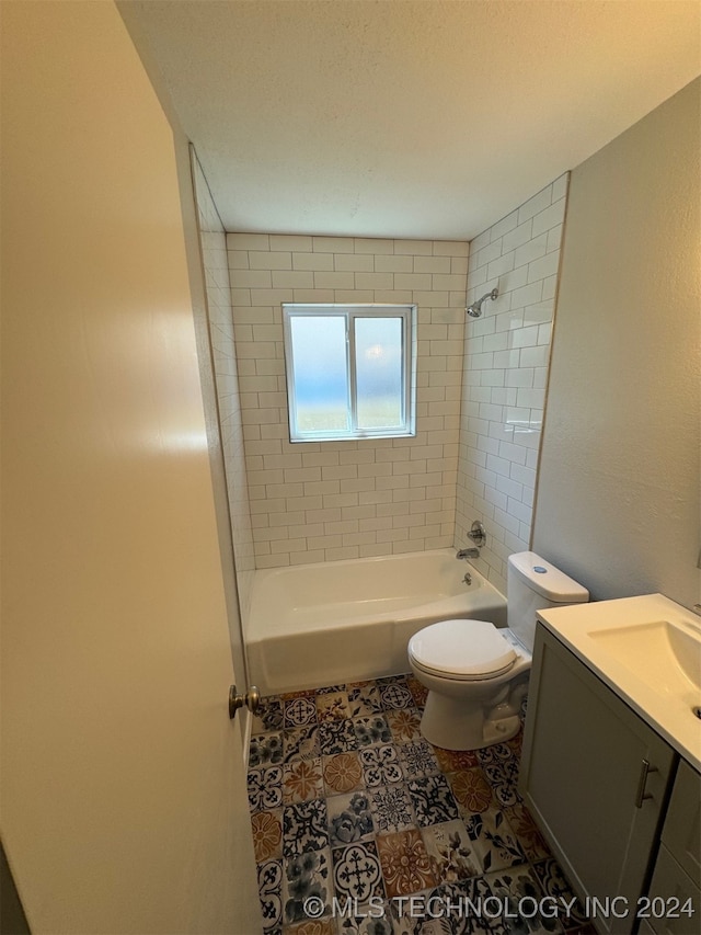 full bathroom featuring vanity, toilet, tile patterned flooring, and tiled shower / bath