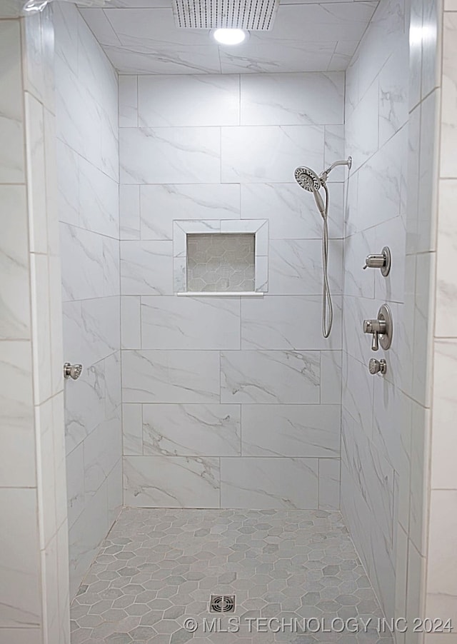 bathroom with a tile shower