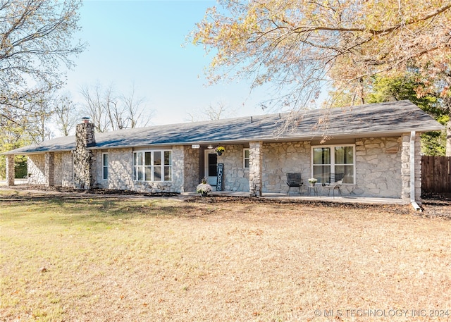 ranch-style house with a front yard and a patio