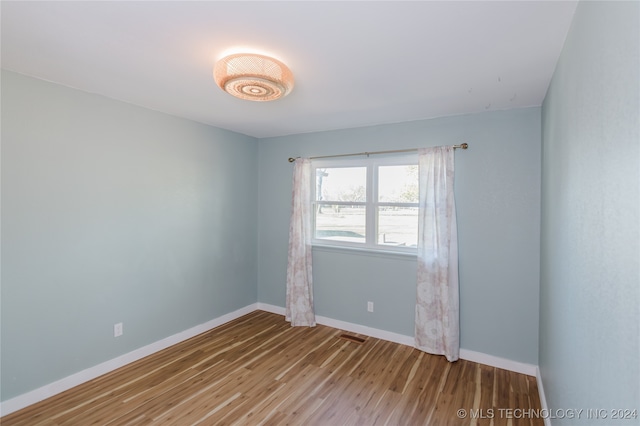 spare room with hardwood / wood-style floors