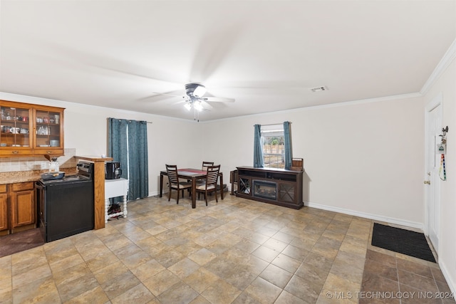 dining area featuring crown molding and ceiling fan