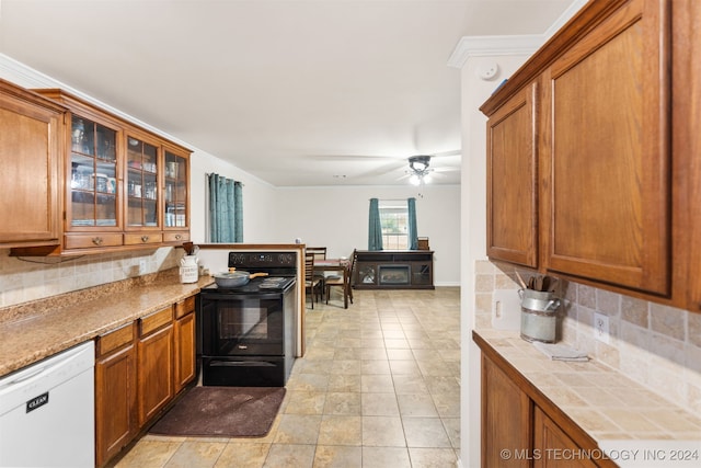 kitchen with tasteful backsplash, black range with electric stovetop, white dishwasher, and ceiling fan