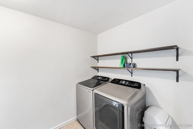 laundry room featuring washer and dryer and carpet floors