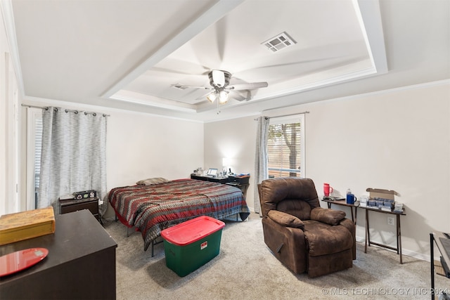 carpeted bedroom featuring ornamental molding, a raised ceiling, and ceiling fan