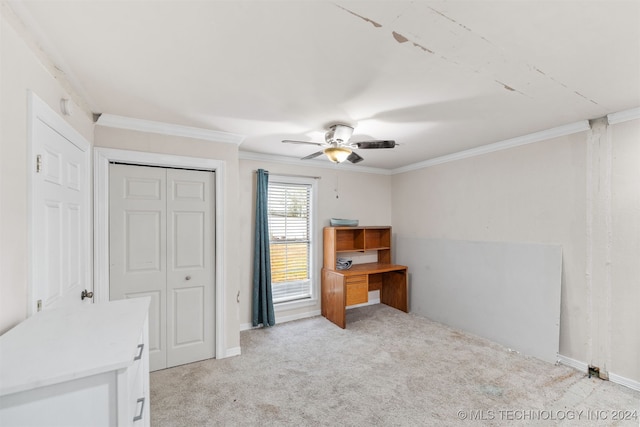 bedroom featuring crown molding, a closet, light colored carpet, and ceiling fan