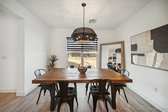 dining room featuring light hardwood / wood-style flooring and a chandelier