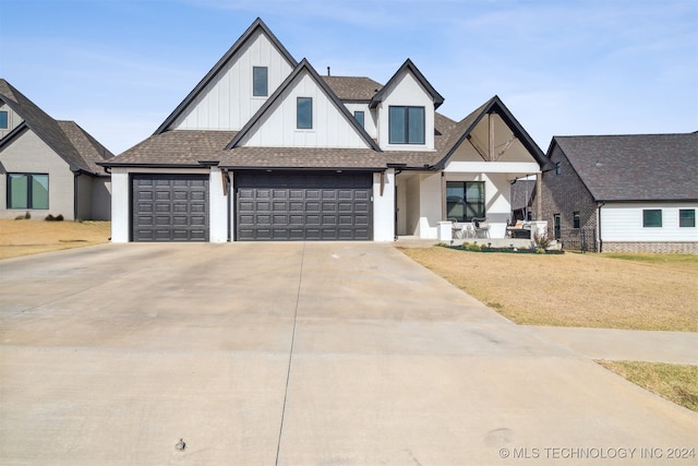 view of front of house featuring a garage and a front lawn