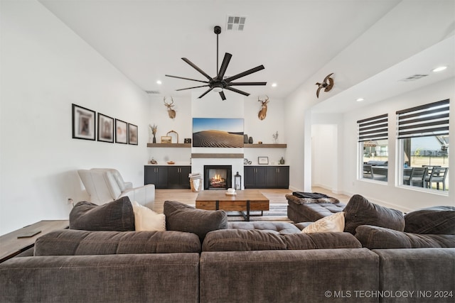 living room with ceiling fan and wood-type flooring