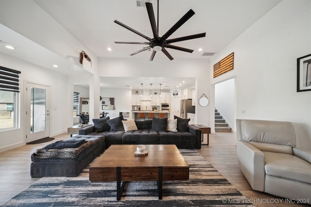 living room with light hardwood / wood-style floors and ceiling fan