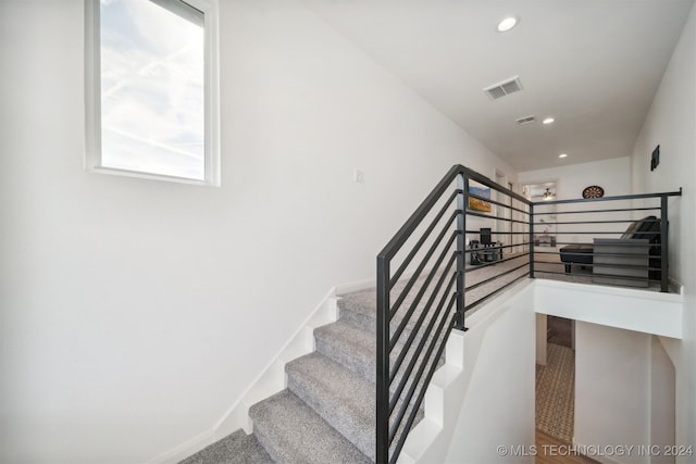 staircase with carpet flooring