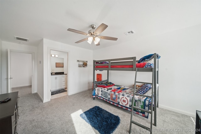 carpeted bedroom featuring connected bathroom and ceiling fan