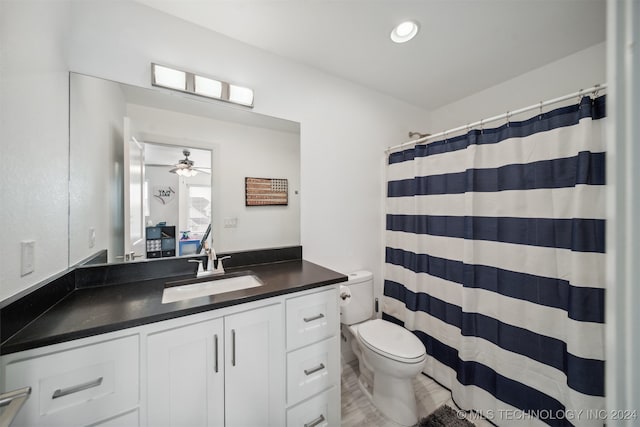 bathroom featuring hardwood / wood-style floors, toilet, ceiling fan, a shower with curtain, and vanity