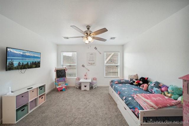 bedroom with ceiling fan, multiple windows, and light colored carpet