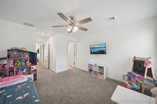 recreation room with ceiling fan and carpet