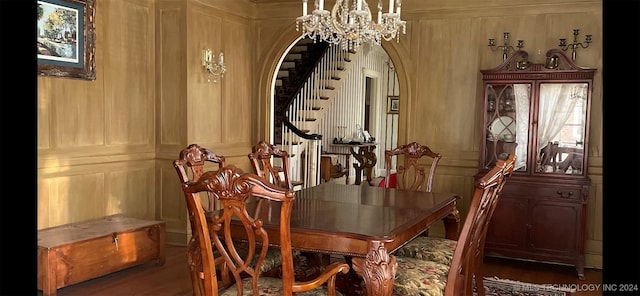 dining area with dark hardwood / wood-style flooring and a chandelier