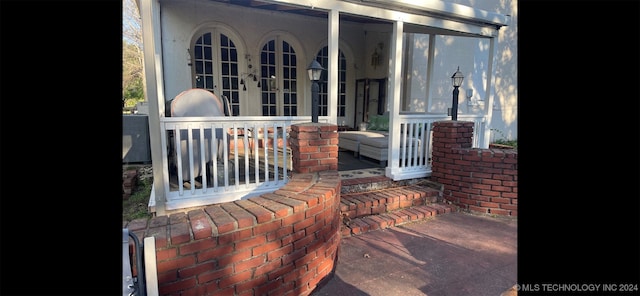 view of patio / terrace with french doors and a porch